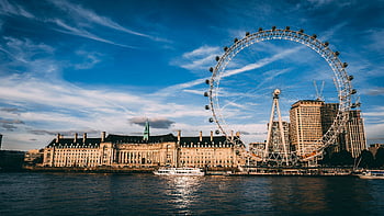 London Eye, River Thames, London cityscape, ferris wheel, city skyline, urban landscape, waterfront view, iconic landmark, travel destination, UK tourism, sunset scene