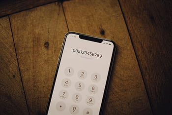 smartphone, numeric dial pad, wooden surface, close-up shot, mobile phone, dial screen, phone keypad, wooden table, digital keypad, smartphone keypad, close-up photo