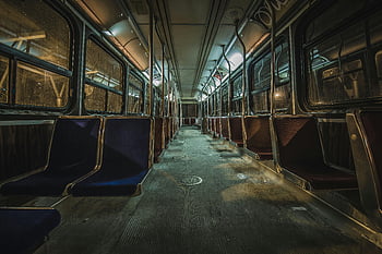 empty train interior, dimly lit, unused urban bus, blue seats, ambient lighting, train seats, interior view, public transportation, abandoned train, train cabin, urban transit