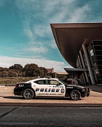 police car, modern building, clear blue skies, day time, Dallas Police, parked car, architectural design, outdoor scene, law enforcement, vehicle, urban setting