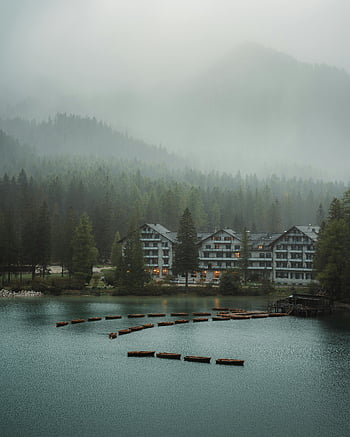 misty lakefront, forested mountains, lakeside hotel, serene morning, misty morning, forest view, lakefront view, mountain hotel, lakeside scenery, hotel view, calm waters
