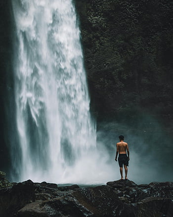 man standing, waterfalls, Ubud, Bali, Indonesia, serene scene, stunning waterfall, natural beauty, travel destination, outdoor adventure, nature photography