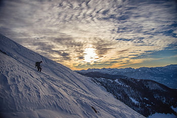 Person on Snow-covered Mountain, hiker, snowy mountain slope, dawn, Radovljica, Slovenia, serene winter landscape, winter scenery, mountain climbing, snow-covered peaks, sunrise over mountains