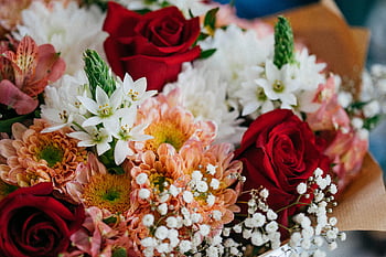 close-up photo, assorted flowers, colorful bouquet, red roses, white star of Bethlehem, chrysanthemums, floral arrangement, vibrant flowers, bouquet details, flower composition, floral close-up
