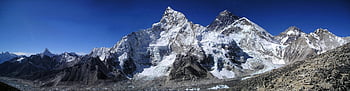 snowy mountains, blue sky, daytime, mountain peaks, snow-covered peaks, alpine landscape, clear sky, mountain range, natural scenery, high altitude, winter landscape