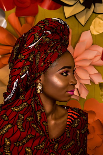 African woman, red floral headdress, vibrant traditional wear, Ibadan Nigeria, portrait, cultural attire, ethnic fashion, traditional headwrap, African fashion, colorful outfit, cultural heritage