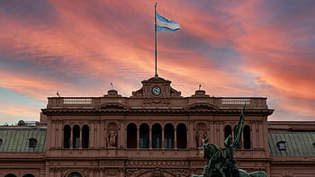 Casa Rosada, Argentinian flag, sunset sky, dramatic clouds, Buenos Aires, Argentina, historic building, presidential palace, national landmark, South America, architecture