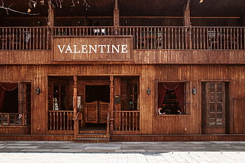 Western-style saloon, rustic wooden facade, Valentine sign, vintage saloon, classic Western atmosphere, wooden saloon front, Western architecture, rustic Western building, wooden saloon doors, Western-style building, Valentine saloon