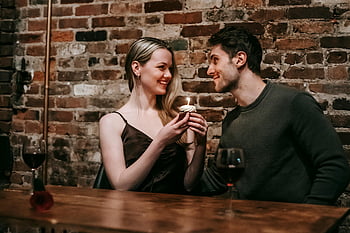 romantic date, cheerful couple, cafe, cupcake with candle, romantic night, couple enjoying, brick wall, wine glasses, intimate moment, cozy atmosphere, romantic setting
