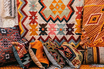 Turkish cushions, colorful rugs, outdoor market, Cappadocia, Turkey, vibrant display, bright cushions, street market, traditional textiles, patterned pillows, cultural crafts
