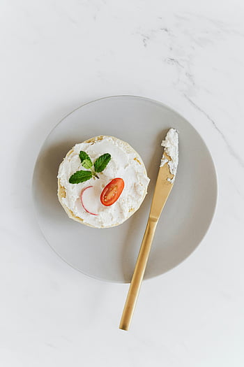 bagel, cream cheese, radish, tomato, mint, minimalist plate, overhead shot, elegant, vegetable, knife, platter
