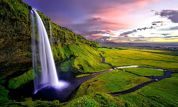 time lapse photography, waterfalls, sunset, vibrant Icelandic sunset, green cliffs, stunning waterfall, nature photography, landscape photography, natural beauty, travel photography, Iceland scenery
