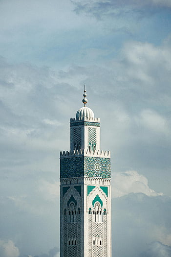 Hassan II Mosque, Casablanca, Morocco, minaret, vertical shot, white clouds, Islamic architecture, blue mosaic, religious landmark, cloudy sky, Moroccan culture