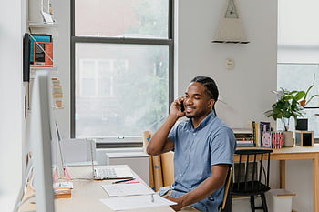 man, desk, office, talking on phone, professional environment, adult man, office work, speaking, phone, workspace, professional setting
