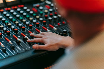 sound engineer, audio mixing console, music production, studio setting, black audio mixer, adjusting audio, mixing console, music studio, audio production, sound mixing, studio equipment