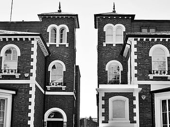 black and white houses, Victorian-style building, classic architectural features, black and white photo, Victorian architecture, building facade, brick houses, arched windows, architectural details, monochrome photography, historical architecture