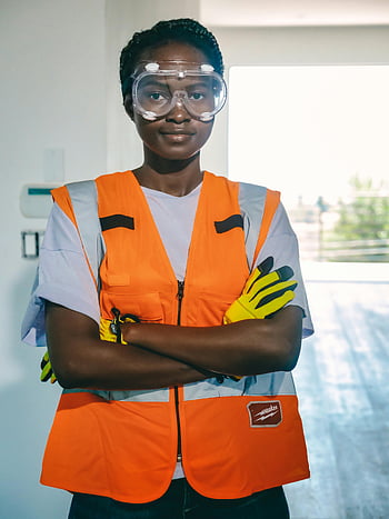 woman engineer, PPE, safety goggles, reflective vest, confident worker, indoor setting, safety gear, protective equipment, construction worker, female engineer, safety vest
