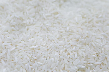 white rice, uncooked rice, close-up shot, rice grains, detailed texture, natural quality, food photography, high-resolution image, culinary ingredients, white rice grains, uncooked white rice