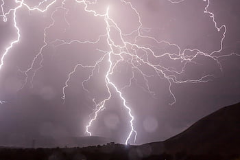 white lightning, heating mountain, night sky, dark hills, dramatic weather, lightning bolts, illuminating night, weather display, natural phenomenon, thunderstorm, electrical storm
