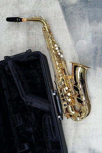 saxophone, black case, concrete surface, elegant saxophone, open case, music instrument, gold saxophone, musical style, saxophone case, musical equipment, instrument case