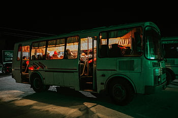 bus at night, passengers inside, warm glow, inviting atmosphere, night scene, public transportation, people in bus, bus interior, nighttime travel, urban transport, street scene