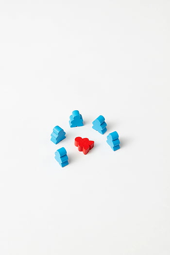 - plastic figurines
- game pieces
- red and blue
- white background
- simple close-up
- contrast
- tabletop game
- miniature figures
- isolated objects
