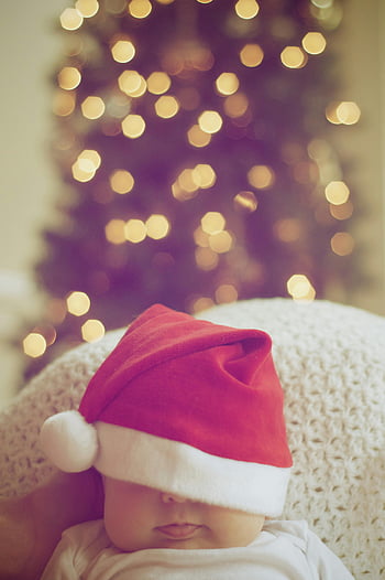 baby, Santa hat, Christmas tree, illuminated Christmas tree, blurred Christmas lights, cute baby, holiday photo, festive photo, Christmas decor, baby photography, holiday season