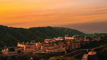Amber Fort, Rajasthan, India, Jaipur, sunset, vibrant sky, aerial shot, historical architecture, mountain backdrop, cultural landmark, fort palace