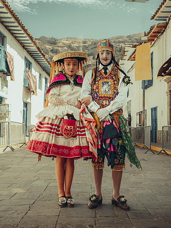 Peruvian costumes, Cusco street, traditional masks, two people, intricate costumes, cultural attire, street scene, Peruvian culture, Cusco Peru, street photography