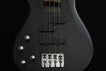 black 4 stringed guitar, electric bass guitar, detailed image, black guitar, guitar strings, guitar body, musical instrument, bass guitar, guitar close-up, guitar hardware, guitar design