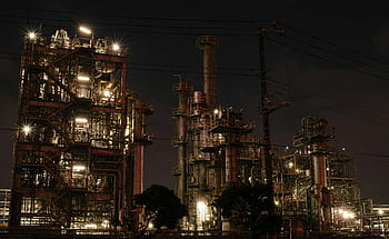 construction site, nighttime, industrial facility, brightly lit, steel structures, machinery, night view, intricate design, factory lights, industrial complex, night photography
