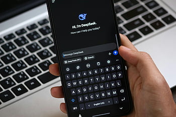 AI chat interface, smartphone, close-up, interaction, DeepSeek, chatbot, mobile device, keyboard, digital communication, technology, user interface