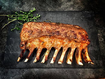 grilled meat, spare ribs, grilled spare ribs, fresh herbs, stone surface, delicious ribs, grilled ribs, meat dish, herb garnish, stone plate, barbecue ribs