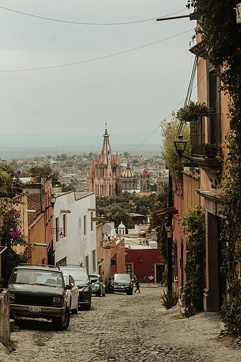 San Miguel de Allende, Mexico, cobblestone street, Parroquia de San Miguel Arcángel, picturesque view, iconic church, Mexican cityscape, colonial architecture, travel destination, cultural landmark, historic town