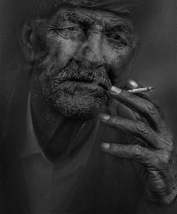 black and white portrait, elderly man, smoking cigarette, facial wrinkles, striking photo, monochrome image, aged man, close-up shot, hand holding cigarette, dark background, high contrast
