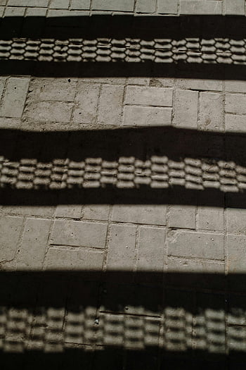 shadows on pavement, light and shadow, abstract design, textured pavement, shadow patterns, pavement texture, urban shadows, shadow art, geometric shadows, shadow play, pavement shadows