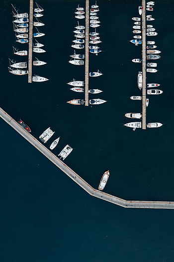 yachts in harbor, aerial shot, boats docked, marina, blue water, harbor scene, yacht marina, waterfront, docked boats, sea view, marina boats
