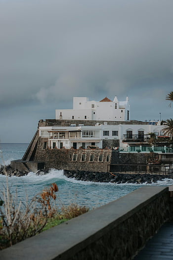 Umberto a Mare, coastal restaurant, Forio Italy, dramatic seascape, coastal architecture, seaside dining, Italian coast, ocean view, waterfront establishment, Mediterranean scenery, coastal ambiance