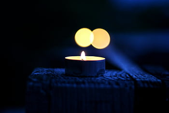 bokeh photography, lighted tealight candle, serene candlelit scene, bokeh effect, warm atmosphere, moody atmosphere, candle light, tealight candle, bokeh lights, candle photography, night scene
