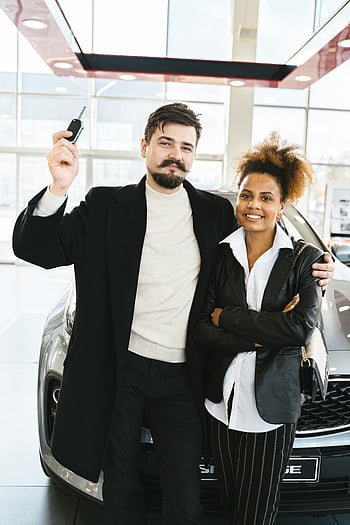 new car purchase, interracial couple, car keys, dealership, celebrating, brand new car, couple standing, car showroom, happy couple, car buying, new vehicle