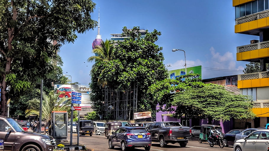 Lotus Tower, Sri Lanka, 2019-20, urban scene, cityscape, vehicles, trees, street view, modern architecture, blue sky, traffic