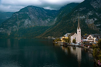 Hallstatt village, Austria, serene lake, mountain backdrop, picturesque view, church near lake, Hallstatt, Alpine scenery, European village, lakeside town, mountain landscape