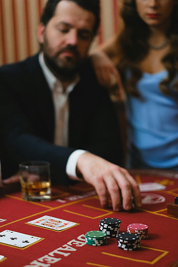 man-in-black-suit-playing-poker-casino-table-poker-chips-cards-indoor-casino-woman-beside-close-up-gambling-poker-game-thumbnail.jpg