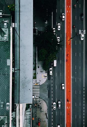aerial view, city highways, São Paulo street, vibrant red bus lane, adjacent buildings, top-down view, busy street, urban landscape, traffic flow, city infrastructure, street layout