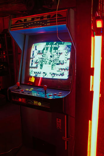 arcade game, retro arcade, neon lights, gaming room, screen and dials, alpha machine, dark room, vintage arcade, illuminated arcade, arcade controls, arcade ranking