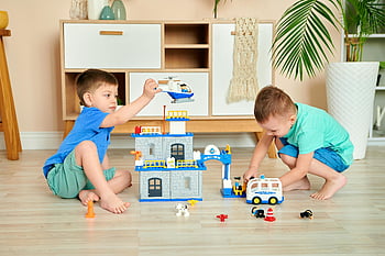 two boys playing, building blocks, indoor playtime, creativity, teamwork, toys, young boys, playroom, educational toys, indoor activities, children playing