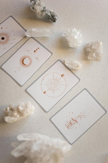 tarot cards, crystals, mystical atmosphere, top-down view, neutral background, close-up, spiritual, divination, crystal healing, card reading, esoteric