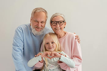 grandparents, granddaughter, family unity, joyful moment, love, indoor photo, multi-generation family, heart gesture, smiling, togetherness, grandparents and granddaughter