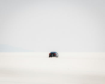 Mustang, Bonneville Salt Flats, Utah, desert drive, lone car, expansive flats, salt flats, car photography, outdoor adventure, scenic drive, remote location