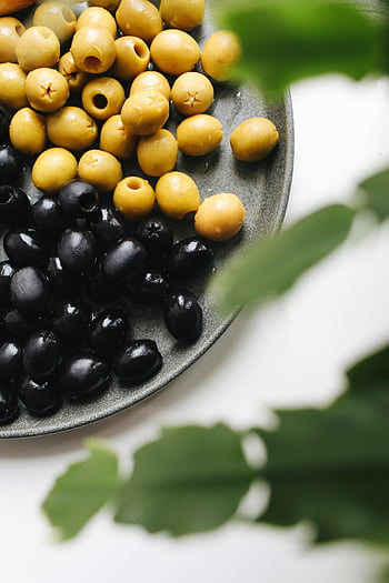 olives, plate, fresh olives, yellow olives, black olives, ceramic plate, vibrant colors, textures, close-up, food photography, healthy food
